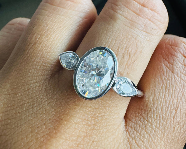 Bezel Set Oval Cut Moissanite Ring Three Stone Engagement Ring in White Gold