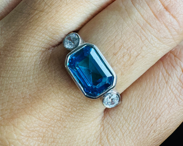 Blue Sapphire Emerald Cut East West Engagement Ring Bezel Set 3 Stone CZ